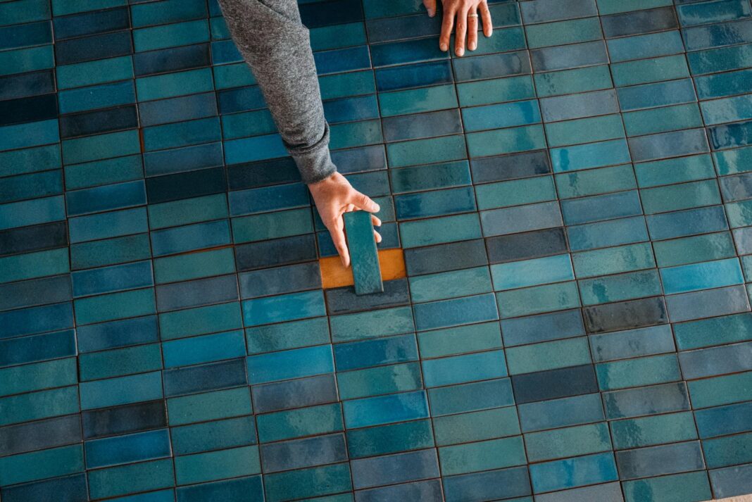 a person laying blue tile