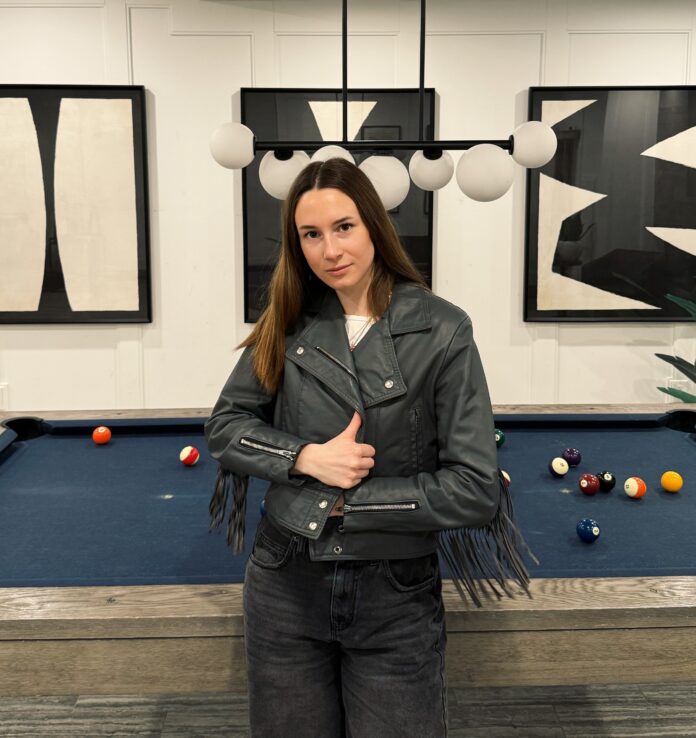 a young woman wearing a leather jacket