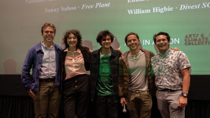 four film students stand in front of a movie screen