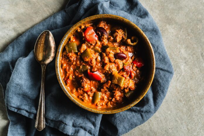 plant based chili in bowl with spoon