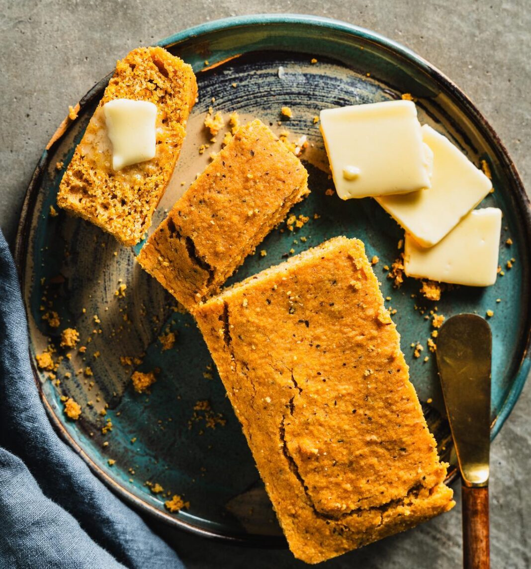 loaf of corn bread on plate with butter