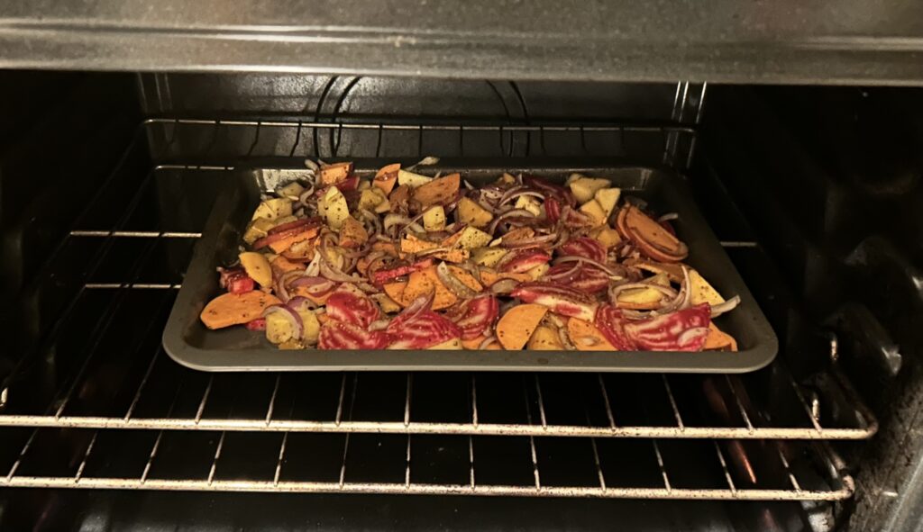 chopped root vegetables on baking sheet in oven