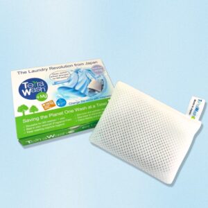 A white box with a shirt pictured on it and the words Terra Wash +Mg, The Laundry Revolution from Japan, next to a white rectangular sachet.