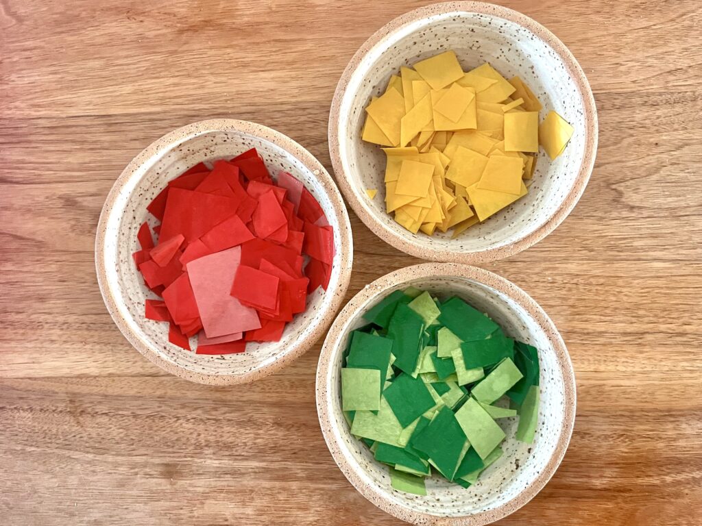 three cups filled with cut up pieces of paper