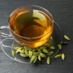 tea in clear mug with seeds around it
