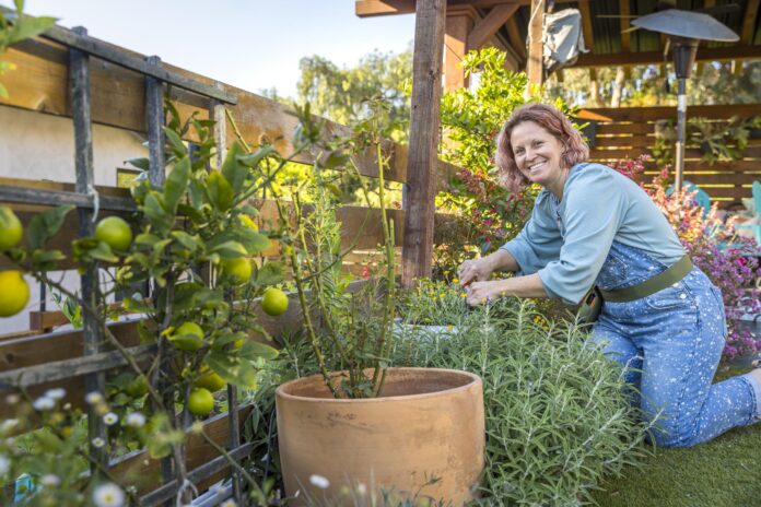 person working in garden looking at camera smiling