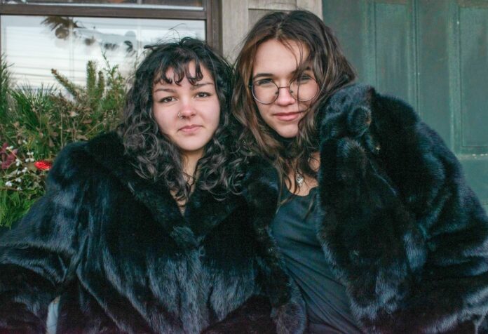 two young women wearing clothes that they thrifted on nantucket