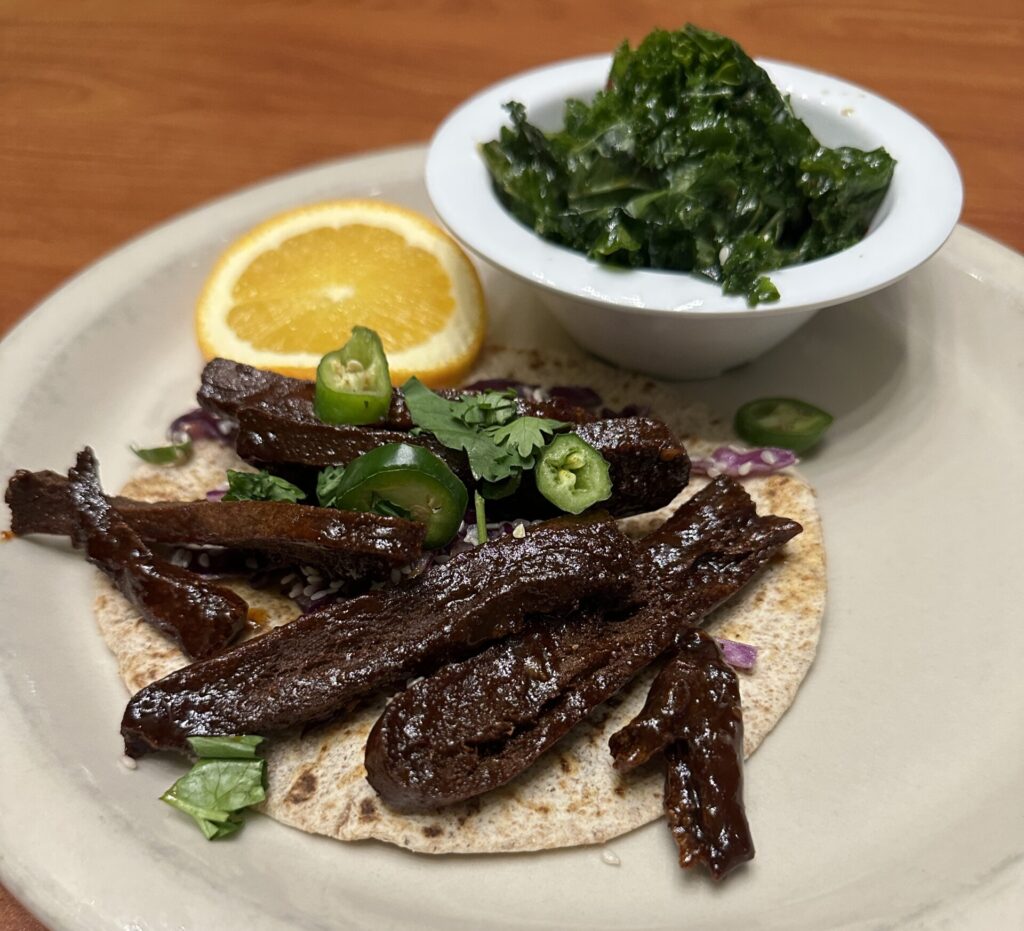 Beefless strips and kale salad on a plate