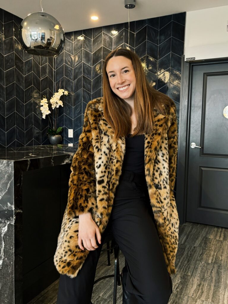 a young woman wearing a faux fur coat