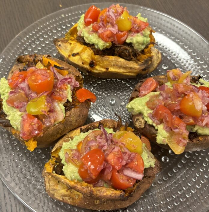 four prepared sweet potato tacos on a clear plate