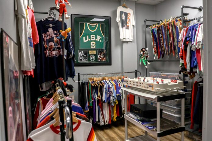 a room full of sports memorabilia and jerseys