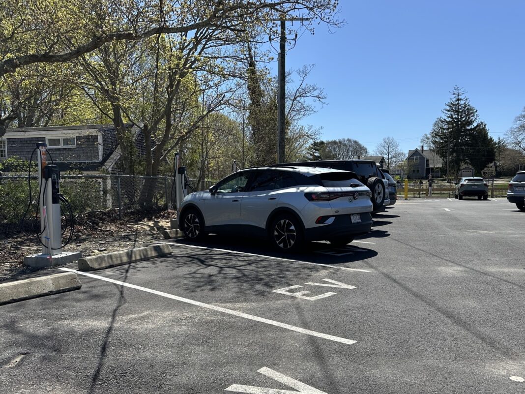 an electric vehicle charging in a parking spot