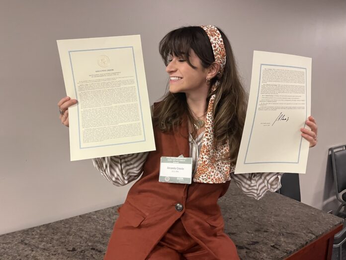 Amanda Cronin with signed Executive Order 14096