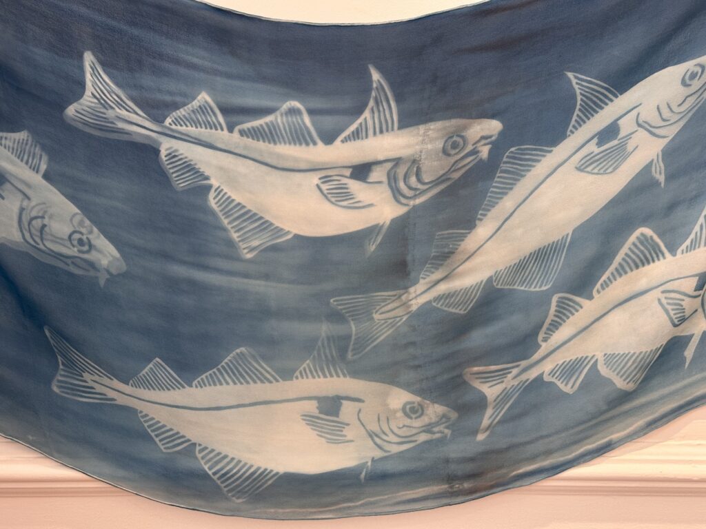 a blue silk banner with fish on it