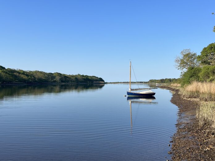 a boat sits on the tisbury great pond