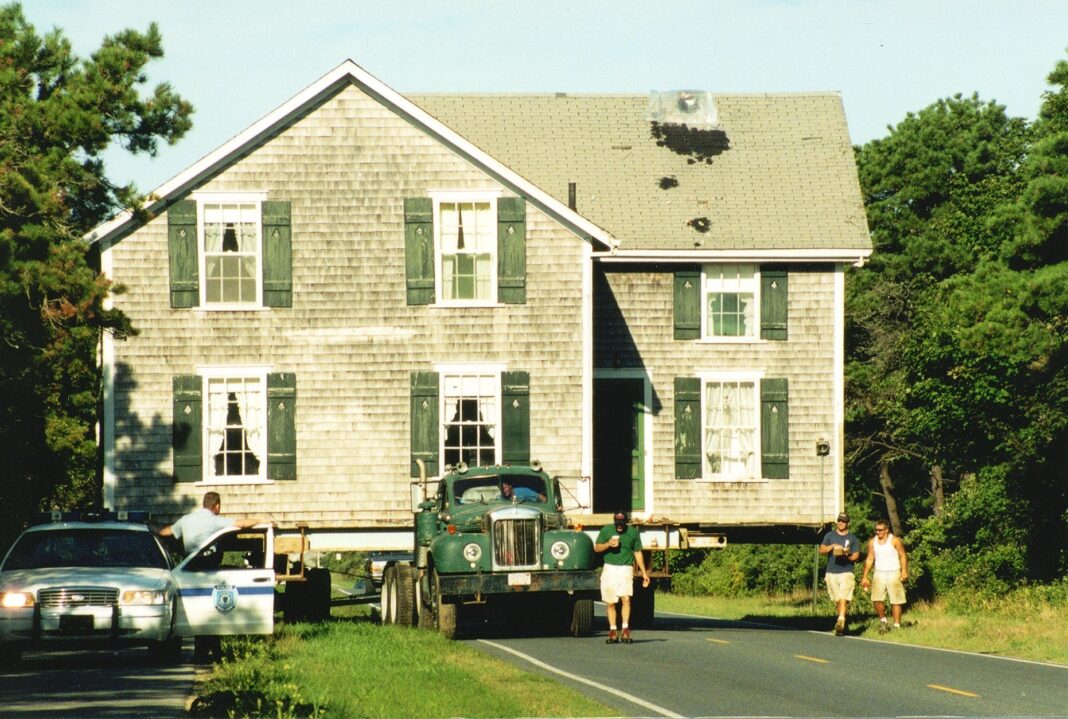 people in front of a nantucket house