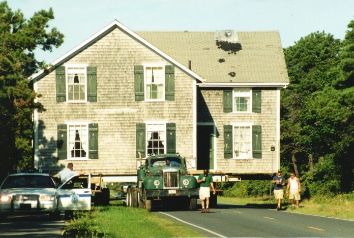 people in front of a nantucket house
