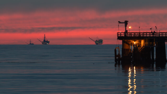 oil platforms at sunset