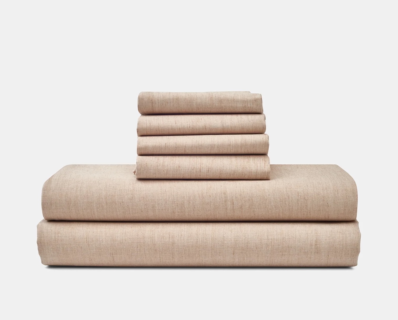 Folded sheets and pillowcases in a light brownish pink color.