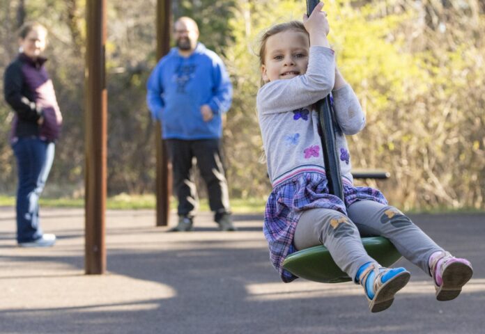 a young child plays at the Discovery Playground at Hinsdale Park