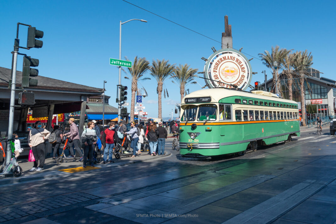 Vintage streetcar in San Francisco, traveling along city tracks with historic charm.