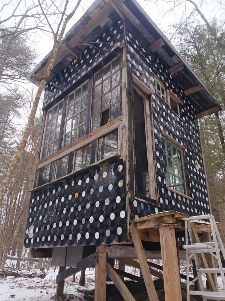 a structure made out of records stands tall in the b-home neighborhood
