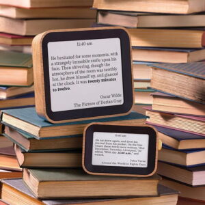 Digital clock displaying the time using literary quotes that mention the current hour, shown on a sleek rectangular screen with a minimal black frame.