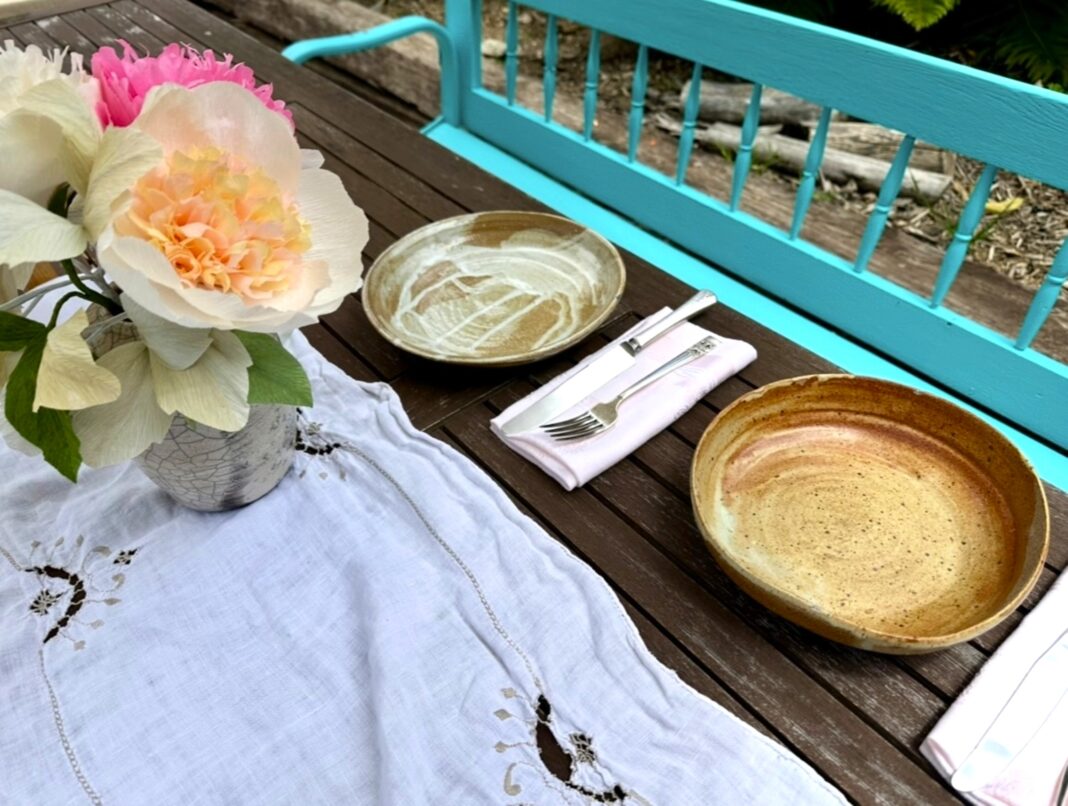 vintage linens and silverware on a table outside