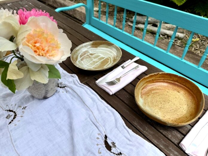vintage linens and silverware on a table outside