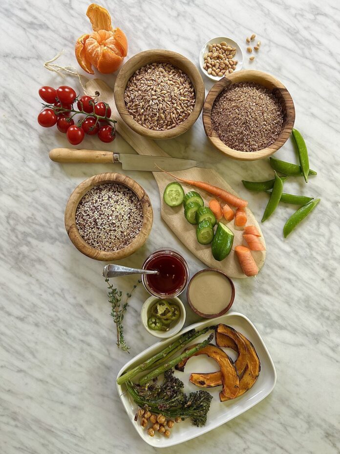colorful grain salad ingredients in bowl and trays