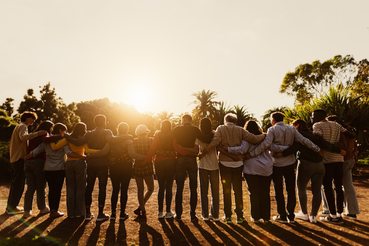 a group hugging at sunset