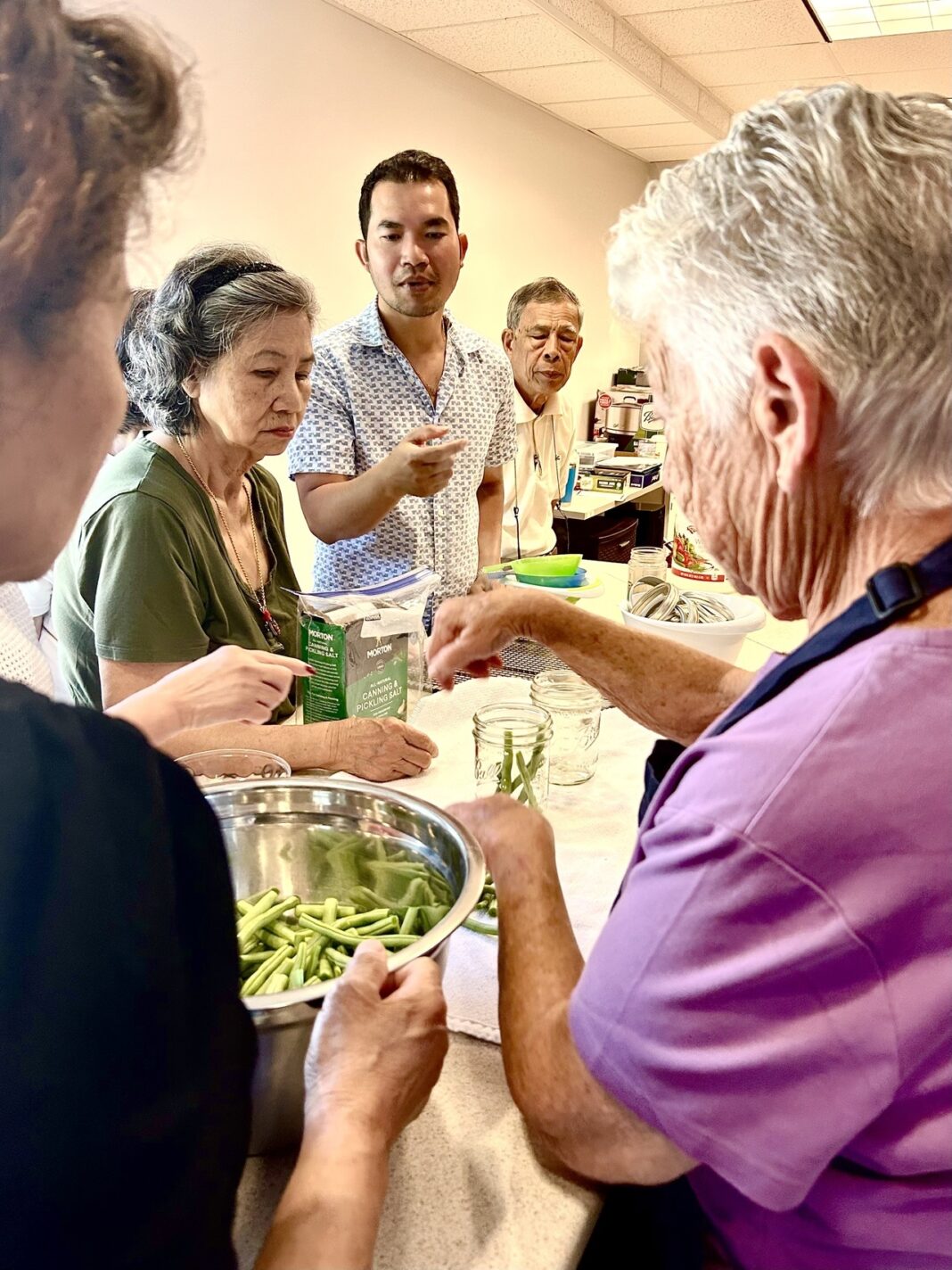 bunly uy leads a group of elders in a project