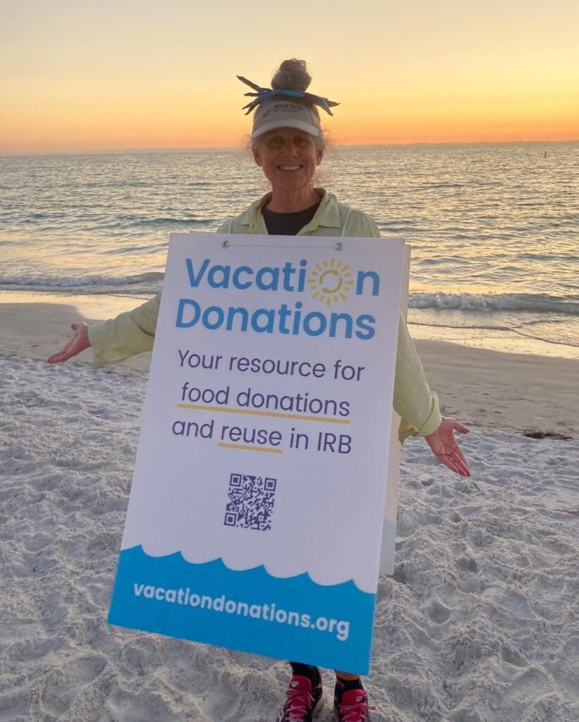 a woman holding a sign that reads "vacation donations"