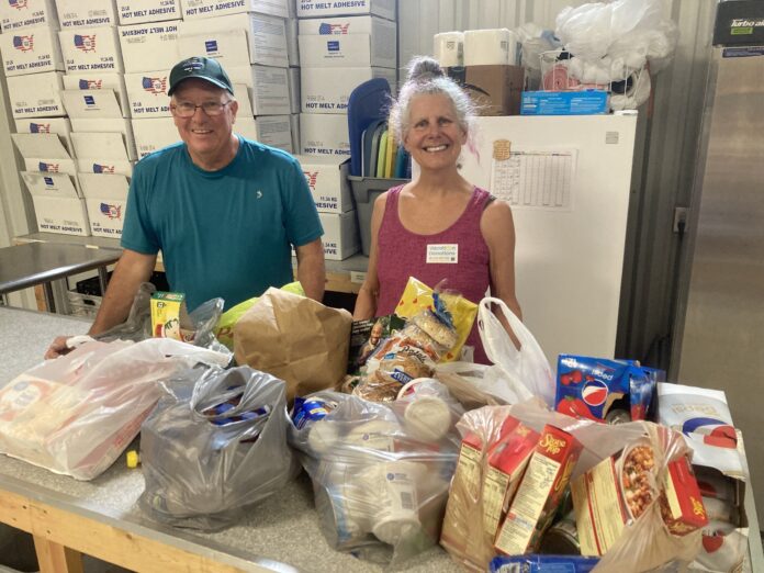 lifeline pantry directors smile in front of donated food