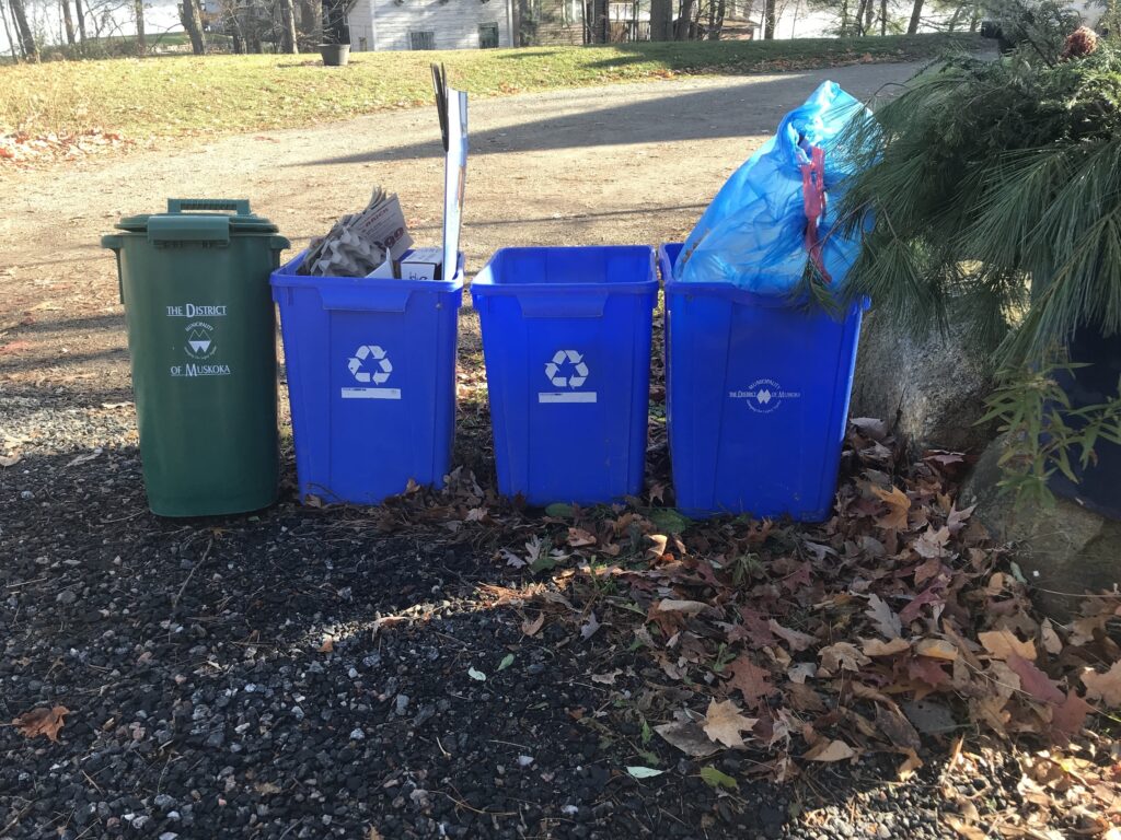 recycle and compost bins in a line