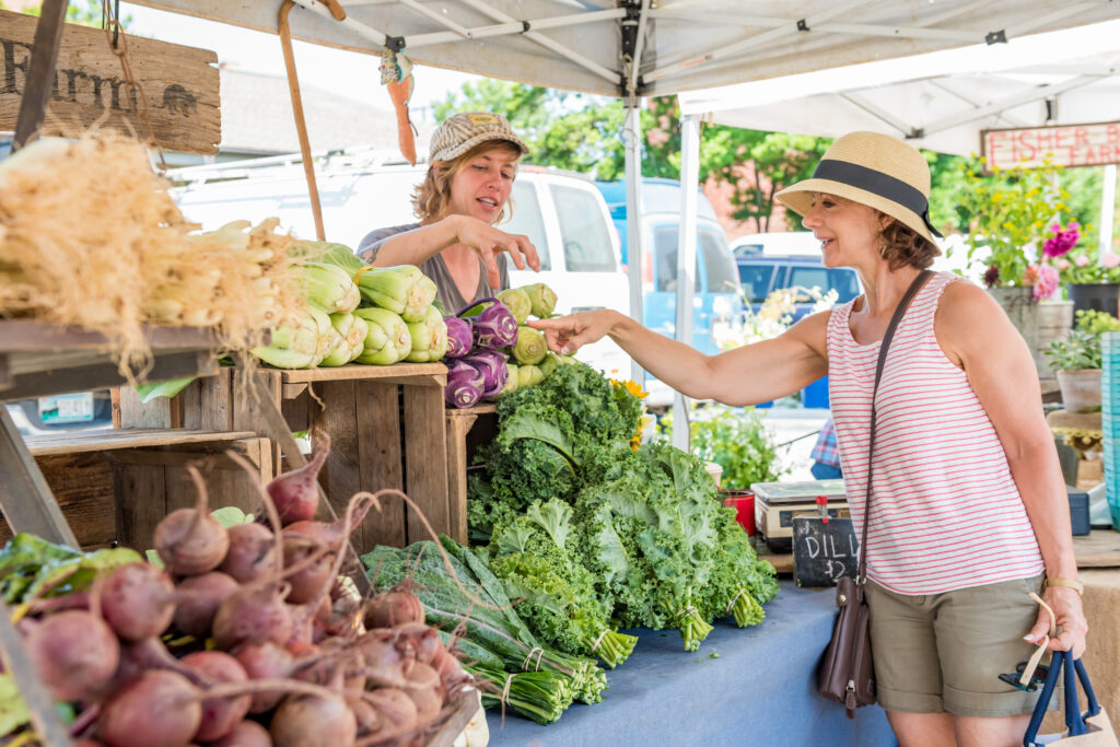 a woman shopping at the north asheville tailgate market