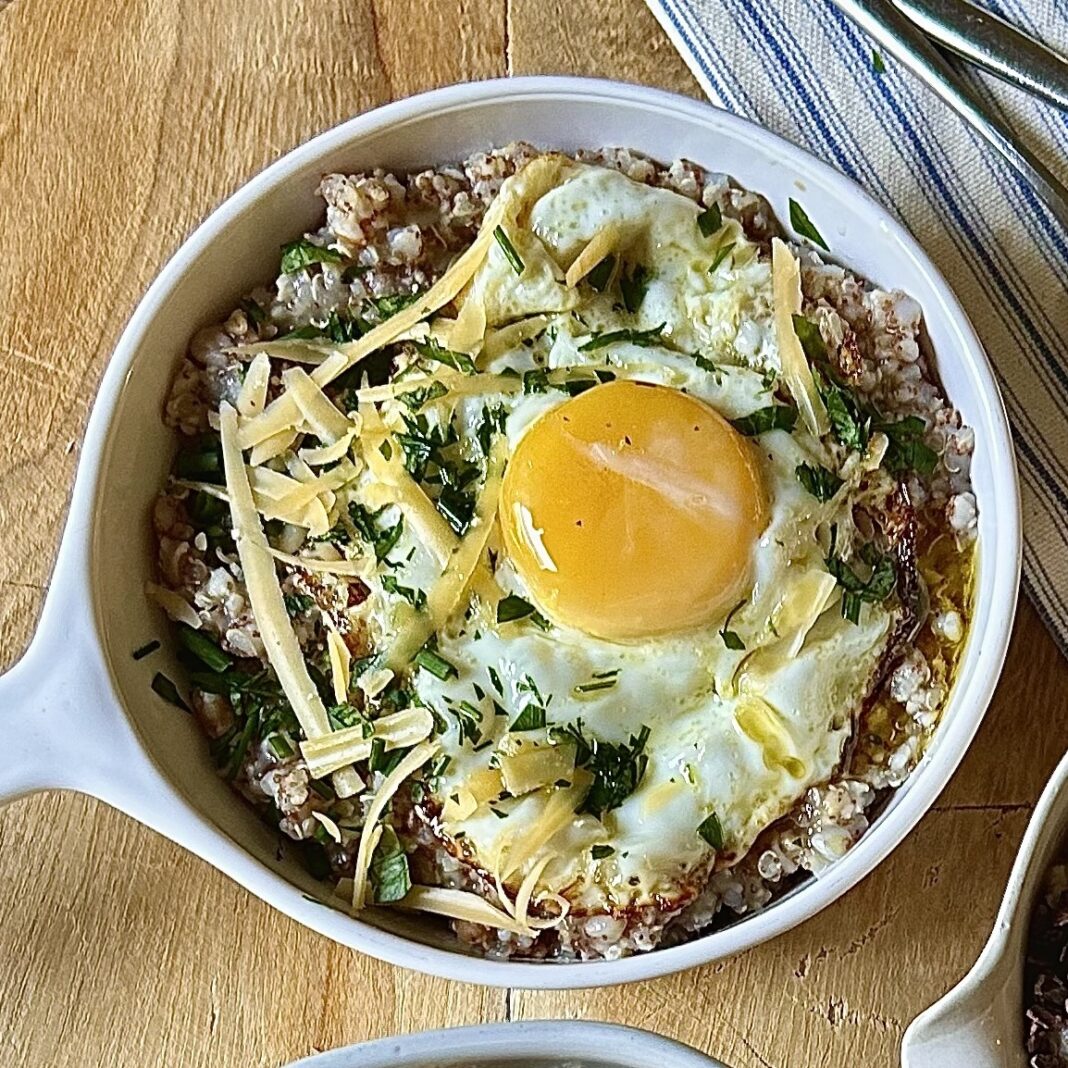 porridge topped with oil-fried eggs and aged cheese