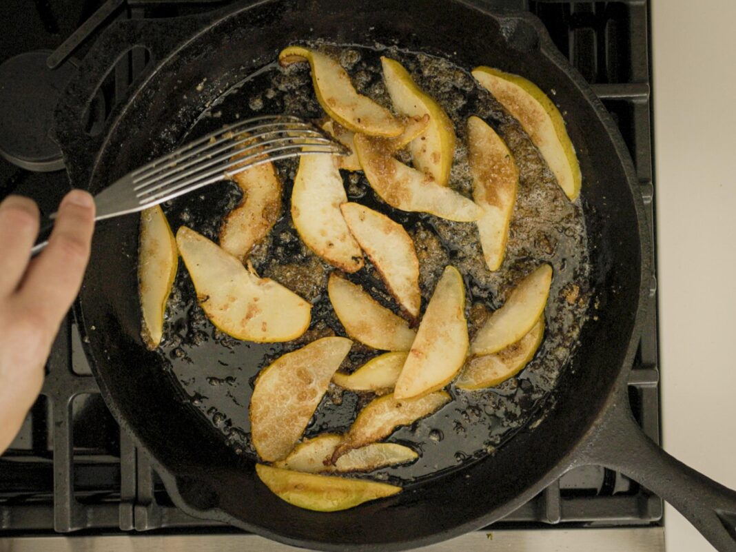 Sliced caramelized pears in cast iron skillet