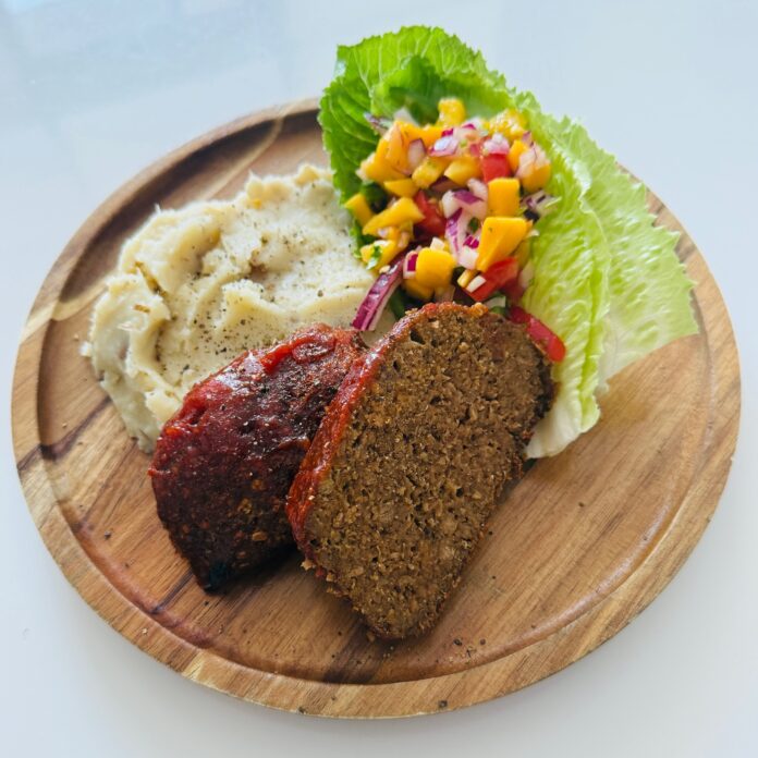 sweet and spicy glazed plant-based meatloaf served with sides