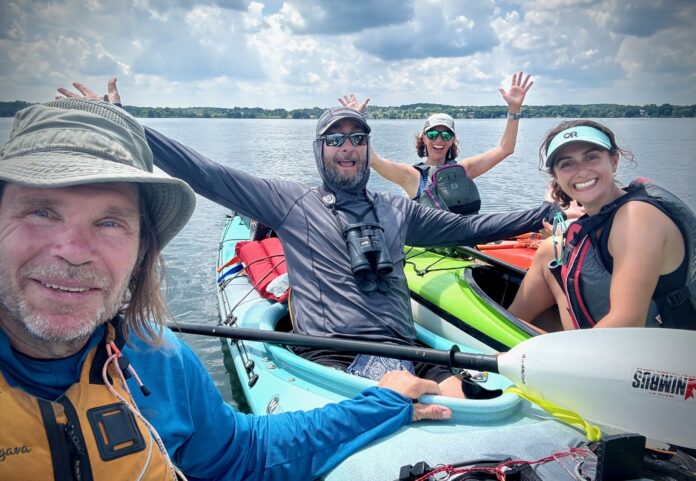 alec ross and other kayakers take a selfie on the water