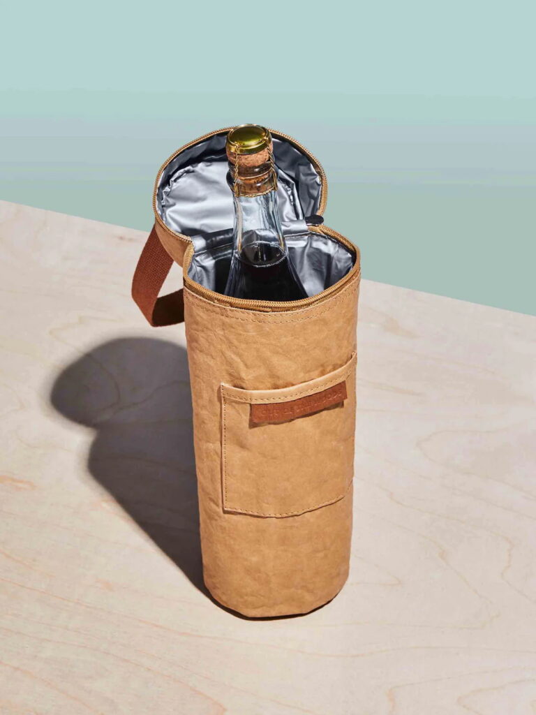 An insulated cooler bag with one bottle of champagne inside.