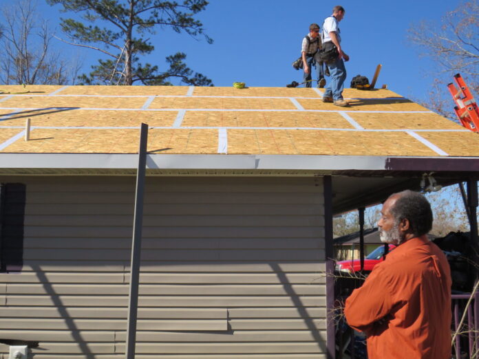 a man standing on the roof of a house