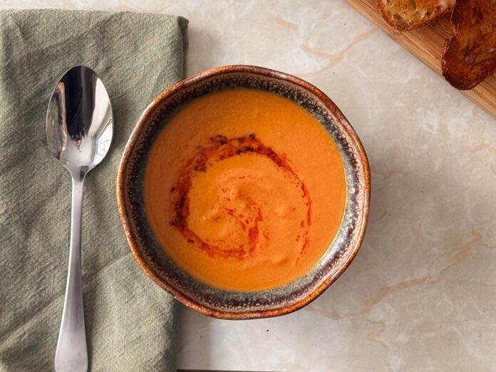 carrot soup served warmly in a bowl