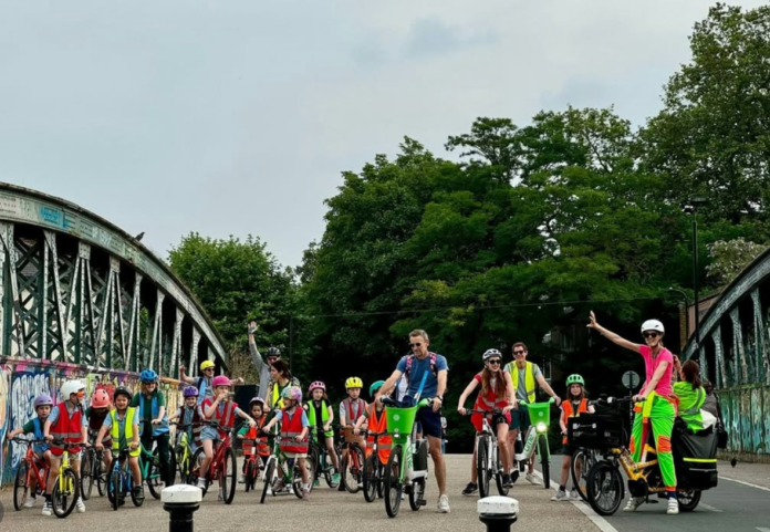 a group of children and parents on bikes