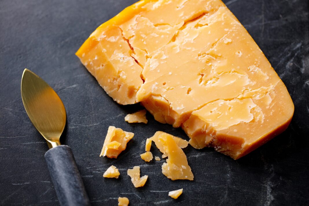 cheddar cheese with a knife
