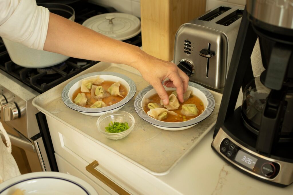 vanessa putting the final touches on the wonton soup