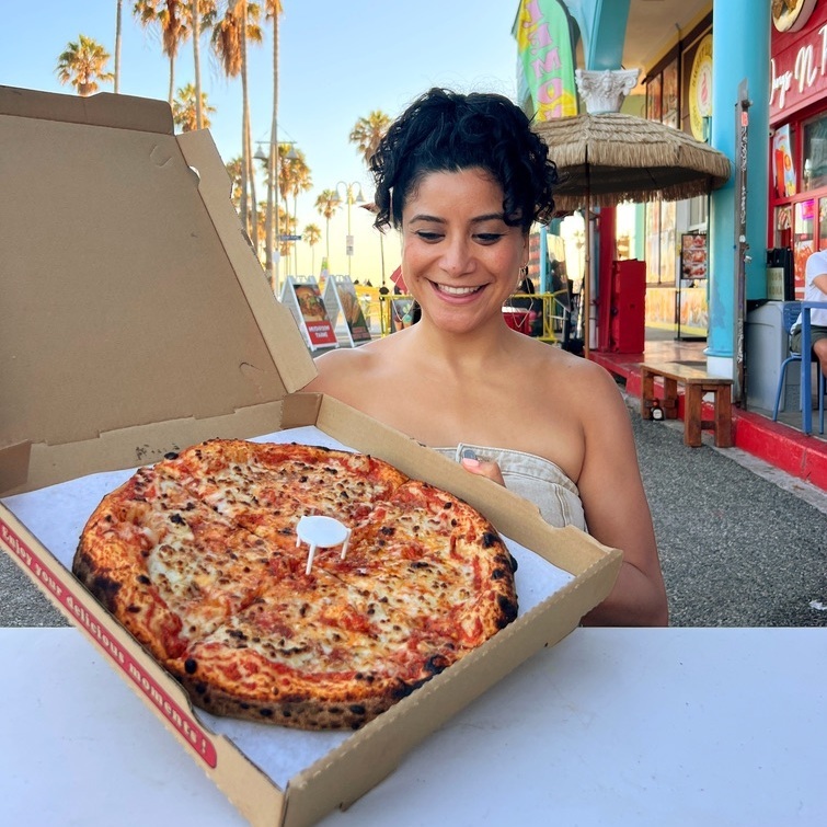 eunice reyes with a detroit-style vegan pizza