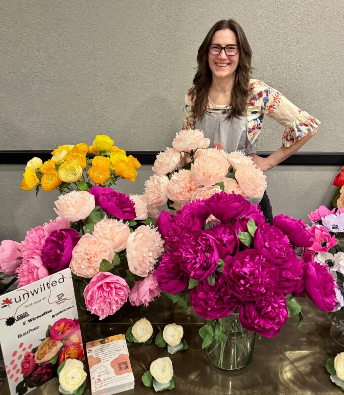liz Carter with vases of hand-made unwilted bouquets