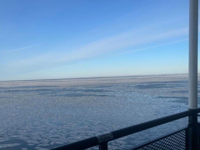 an almost fully frozen over body of water