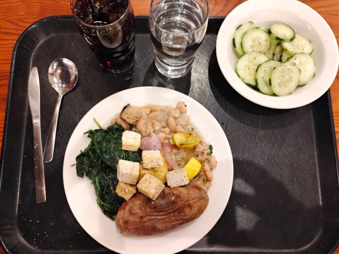 vegan college dining hall dinner featuring potatoes, spinash, tofu, and cucumber